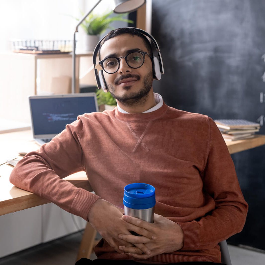 handsome-programmer-in-headphones-listening-to-mus-2023-11-27-04-56-48-utc.jpg